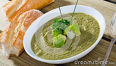Broccoli cream soup with baguette Stock Photo