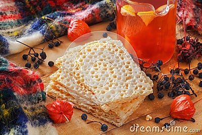 Dietary crackers - plate snacks and red tea with lemon. Wild forest berries, physalis on a wooden table Stock Photo