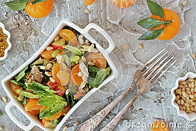 Dietary spinach salad and Mandarin oranges with dressing of mustard and pine nuts Stock Photo