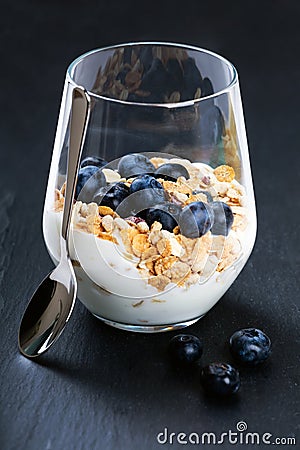 Dietetic breakfast - yoghurt with muesli and huckleberries Stock Photo