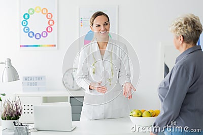 Dietician welcoming elderly client Stock Photo