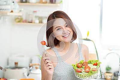 Dieting concept. Healthy Food. Beautiful Young Asian Woman eating fresh vegetable salad. Loosing Weight concept Stock Photo