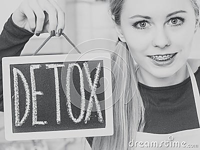 Happy woman holding board with detox sign Stock Photo