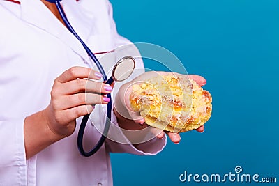 Dietitian examine sweet bun with stethoscope Stock Photo