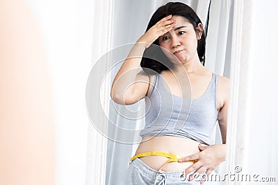 diets fail concept with sad Asian woman not success losing weight Stock Photo
