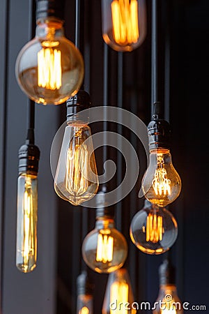 Diferent vintage tungsten filament lamps hanging from the ceiling Stock Photo