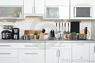 Different appliances, dishes and utensils on kitchen counter Stock Photo