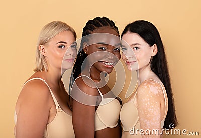 Different Beauty. Three Body Positive Females In Underwear Posing Over Beige Background Stock Photo