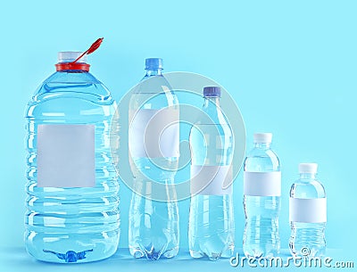 Different bottles of pure water with blank tags Stock Photo