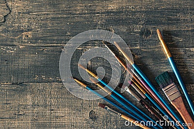 Mockup Different brushes on dark wooden desk Stock Photo