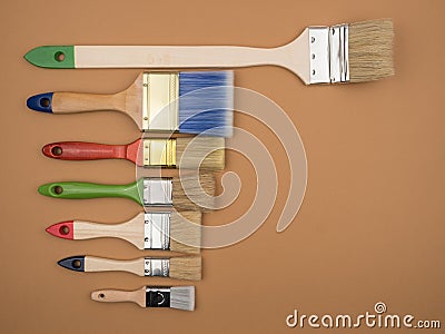 Different brushes for painting on a beige background. Stock Photo