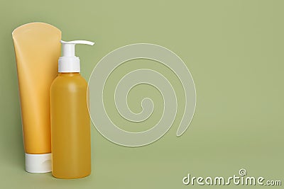 Different cleansers on olive background, space for text. Cosmetic product Stock Photo