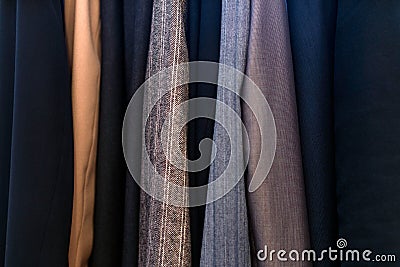 Different clothing textures in the closet, business suits Stock Photo