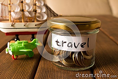 Different coins in glass jar. The concept of travel savings Stock Photo