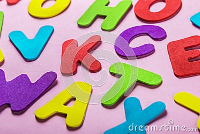 Different color letters on a pink background Stock Photo