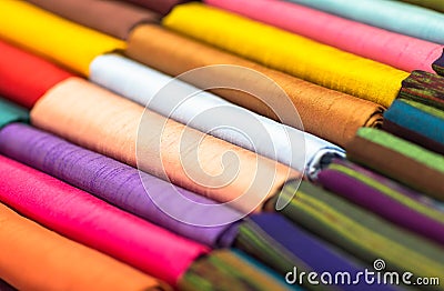 Different colored fabrics neatly folded for display. Closeup. Stock Photo
