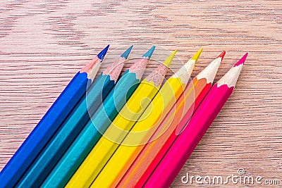 Different colored pencils photo with space for text. Seven pencils of rainbow colors lie on the table. Copyspace. Back to school. Stock Photo