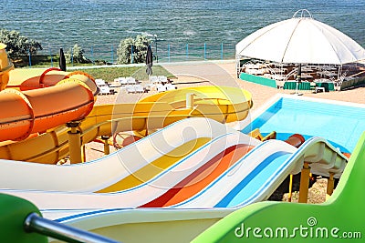 Different colorful slides in water park on day Stock Photo