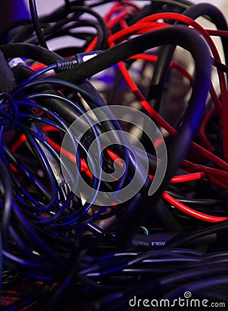 Different colors of tangled cables in disorder Stock Photo