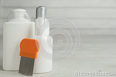 Different cosmetic products and lice comb on light table. Space for text Stock Photo