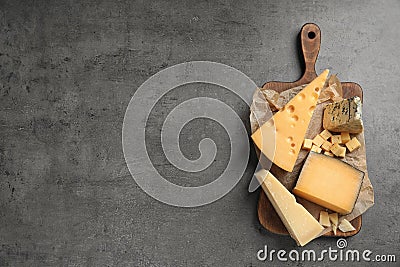 Different delicious cheeses served on grey table, top view Stock Photo