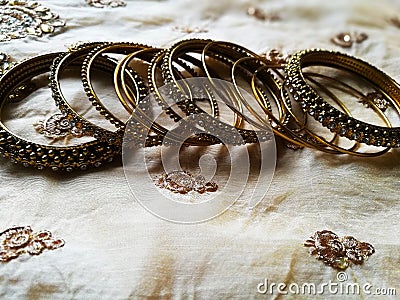 Different designed gold bangles in silk background Stock Photo