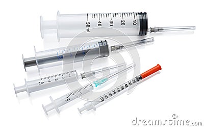 Different disposable syringes with needles on white background Stock Photo