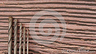Different drill bits for machine on wooden background Stock Photo