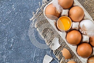 Different eggs in carton pack on dark stone table. Stock Photo