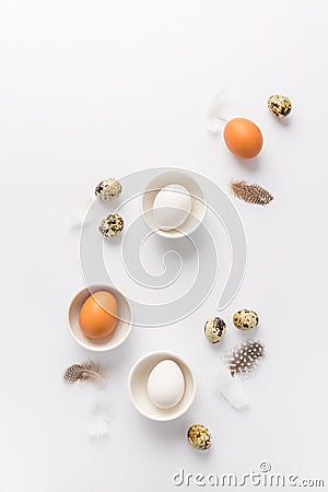 Different eggs with feathers for Easter on white background Stock Photo