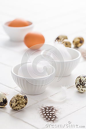 Different eggs with feathers for Easter on white background Stock Photo