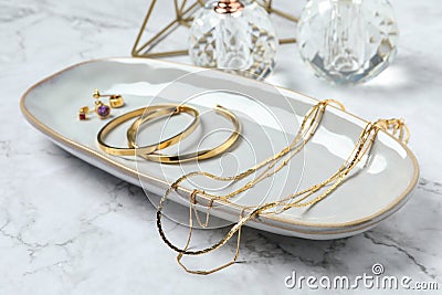 Different elegant bijouterie on white marble table, closeup Stock Photo