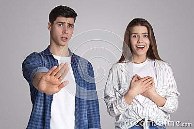 Different emotions, joy and rejection. Young disgruntled man make stop gesture with hand, refuses offer Stock Photo