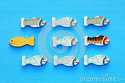 different fish swimming opposite way of identical ones. Courage and success concept. Stock Photo