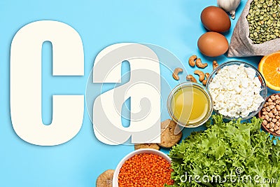 Different fresh products with high amounts of easily absorbable calcium on turquoise background, flat lay Stock Photo