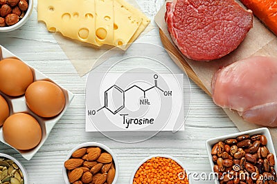 Different fresh products and paper with Tyrosine chemical formula on white wooden table, flat lay. Sources of essential amino Stock Photo