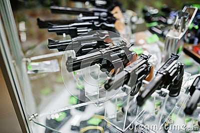 Different guns and revolvers on shelves store weapons on shop ce Stock Photo