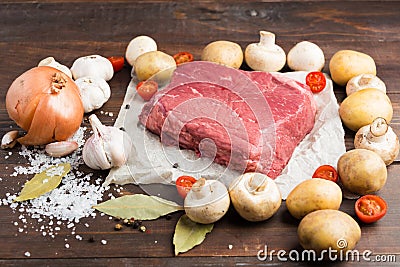 Different ingredients for cookig of beaf over wooden table Stock Photo