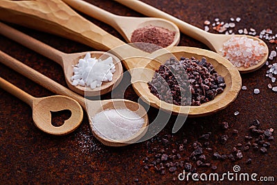 Different kind of salt on wooden board Stock Photo