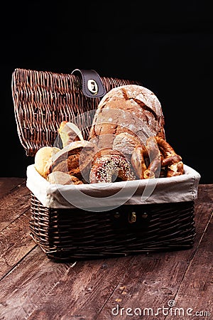 Different kinds of bread and bread rolls on board from above. Kitchen or bakery poster design. Stock Photo