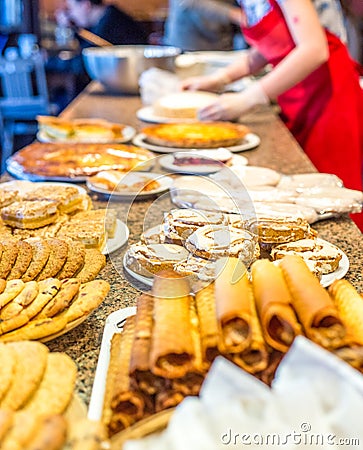 Different kinds of homemade cookies on plates at table Stock Photo