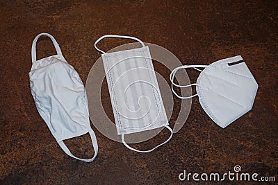 3 different kinds of white face masks on a kitchen counter. Stock Photo