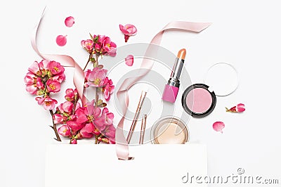 Different makeup cosmetic. Ball blush rouge lipstick concealer bottle of perfume makeup brush spring pink flowers in Stock Photo