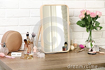Different makeup products and accessories on dressing table Stock Photo