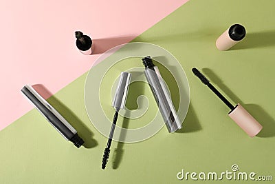 Different mascaras on color background, flat lay Stock Photo