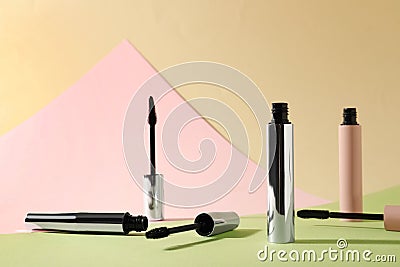 Different mascaras for eyelashes on color background Stock Photo