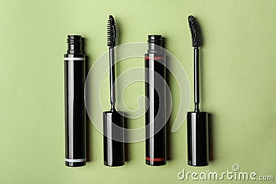 Different mascaras for eyelashes on light background, flat lay. Makeup product Stock Photo