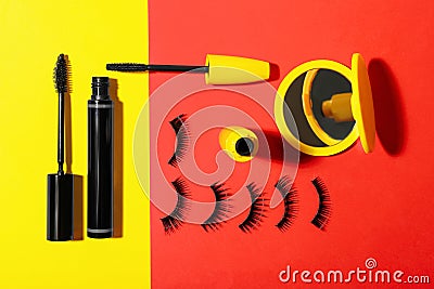 Different mascaras, fake eyelashes and mirror on color background, flat lay. Makeup product Stock Photo