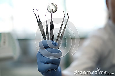 Dental intruments in hand Stock Photo