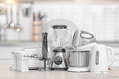 Different modern kitchen appliances on table indoors. Interior element Stock Photo